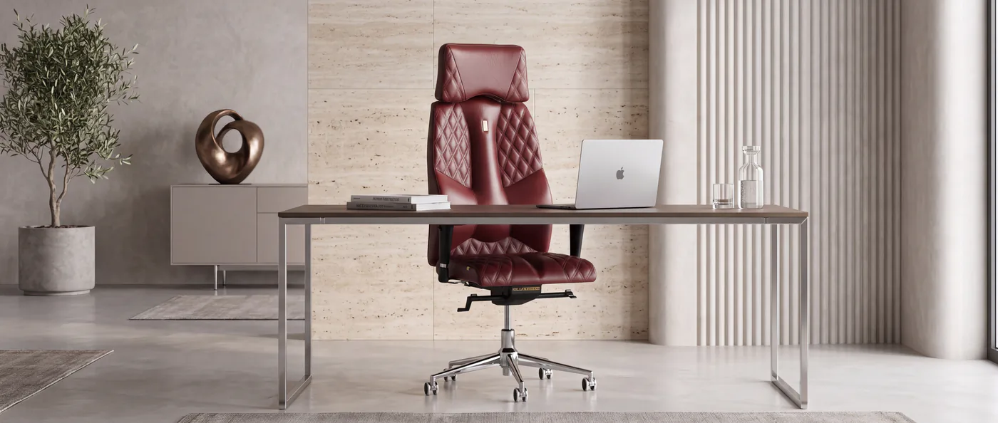 Burgundy quilted Kulik System Business chair at a modern stone-walled desk
