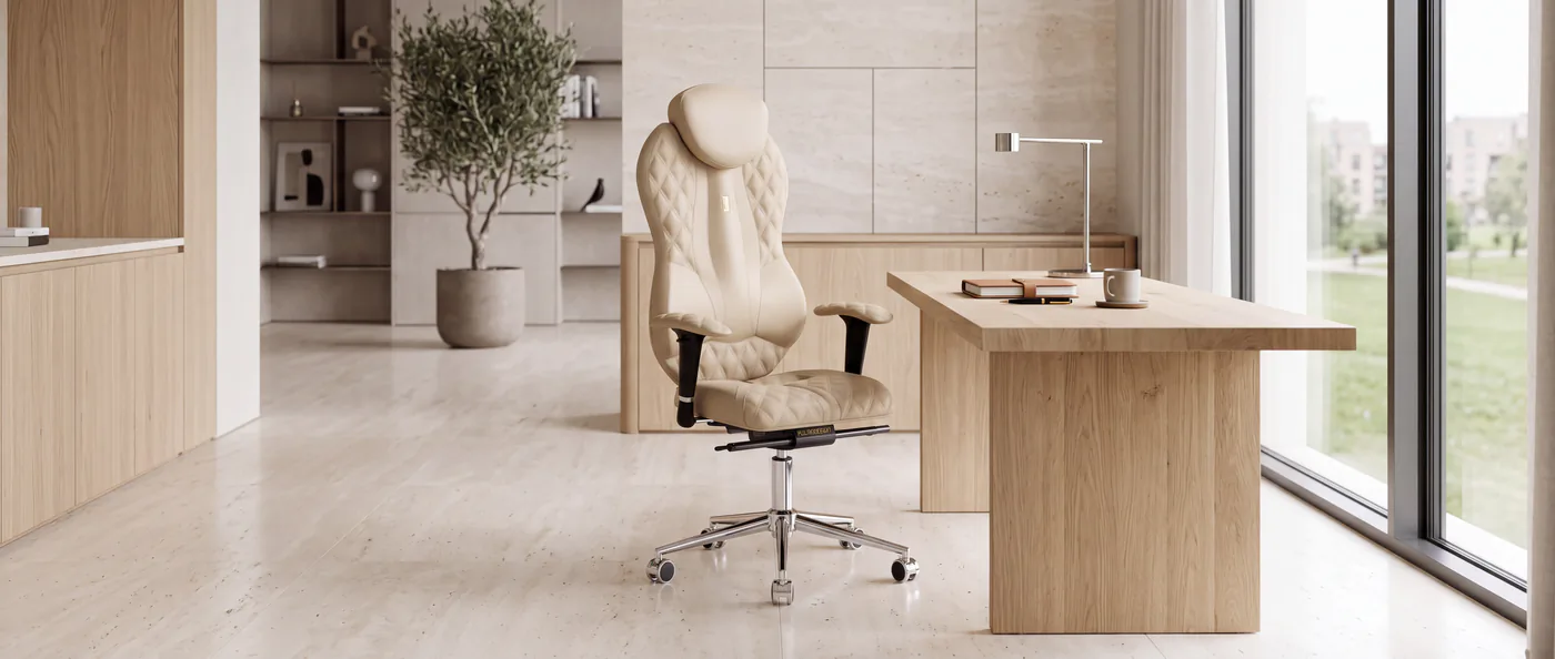 Cream quilted Kulik System Grand chair in a bright wood-and-stone office